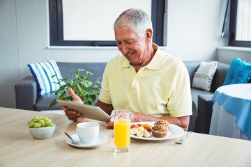 Senior man using a digital tablet
