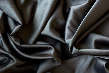 Obraz premium Black abstract background luxury cloth or liquid wave or wavy folds, silk or satin material with waving lines
