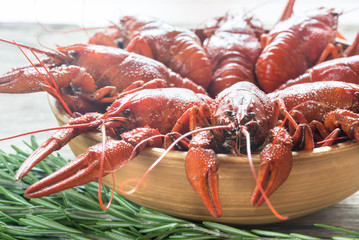 Bowl of boiled crayfish on the wooden table