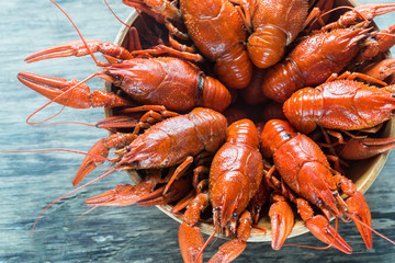 Bowl of boiled crayfish on the wooden table