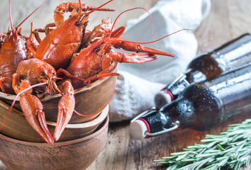 Bowl of boiled crayfish with bottles of beer