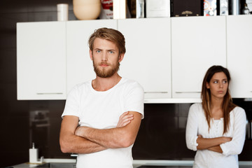 Displeased handsome man in quarrel with his girlfriend background.