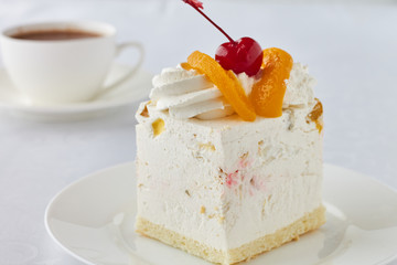 Cake dessert with peach, cherry and hot chocolate