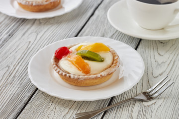 Tartlets with cream and fruits, orange, kiwi, cherry
