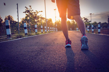 handsome man running on road with solar power plant in morning ;Healthy lifestyle with green energy