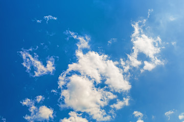 Fototapeta na wymiar Blue sky with white fluffy cumuli clouds.