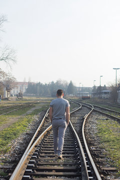 Man walking on railroad tracks