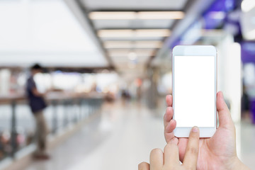Female using mobile phone with blur shopping mall