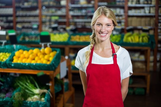 Smiling female staff standing in organic section