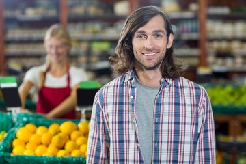 Smiling man standing in organic section