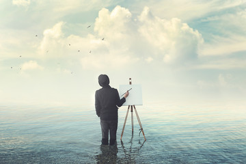 Obraz premium painter with brush with canvas easel finding insiration in water