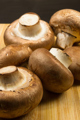 mushroom champignons on a wooden Board