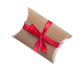 Brown gift box with red ribbon isolated on white