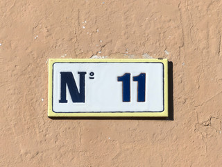 Street sign reading the number eleven.
