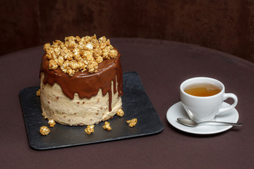 Chocolate cake with caramel and popcorn, close up
