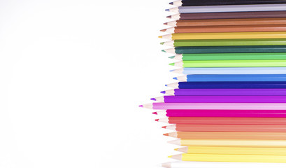Jagged row of coloured pencils on white with space for text