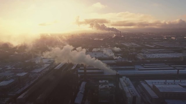 Yellow tone cinematic style video of industrial region in big city. Smokestack in factory with yellow sky and clouds. Industrial pollution.