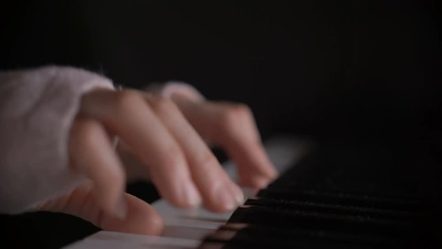 woman's hand playing the piano