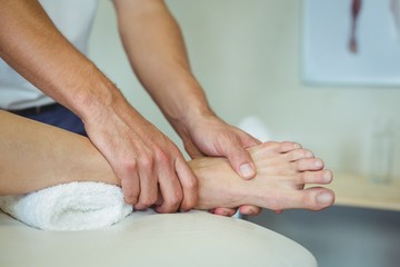 Physiotherapist giving leg massage to a woman