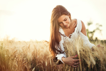Beautiful woman in wheat meadow