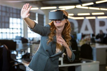 Cheerful woman using virtual reality simulator 