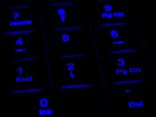 numeric keypad on black computer keyboard with led backlight, shallow depth of field