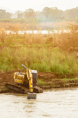 Shovel bucket on river bank , lift loads, construction machinery