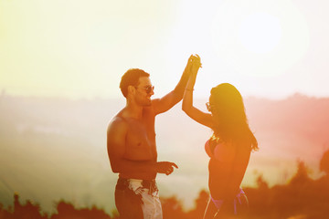 Couple dancing during sunset
