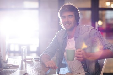 Portrait of man taking coffee break in office