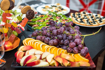 delicious red grape and fruit slices on the table