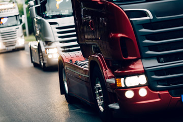 Obraz na płótnie Canvas Trucks being driven on road