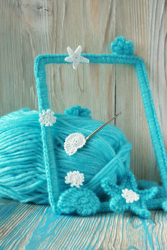 Marine background with cotton lace crochet elements: stars, shells, flowers and frame