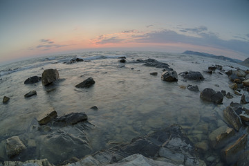 Obraz premium Sunset over the coast with stones of Black Sea, Russia