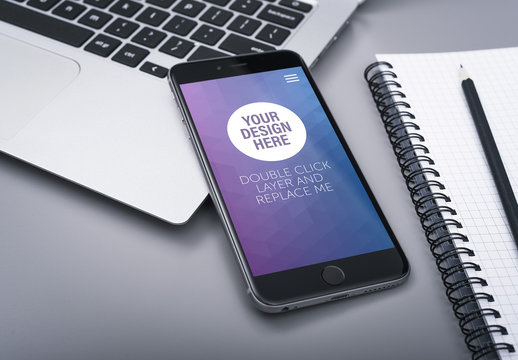 Closeup of Smartphone with Notebook Mockup