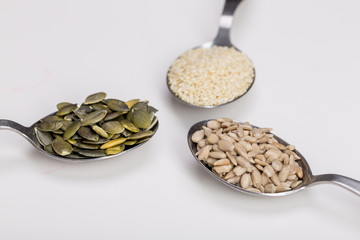 Sesame, pumpkin and sunflower seeds on white background isolated