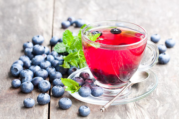 blueberry  tea with mint leaves on wooden background