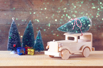 Wooden car carrying a christmas tree