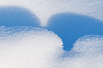 Obraz premium Fluffy snowdrifts and blue shadows from them. Natural winter bac