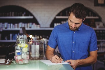 Male hairdresser filling a form