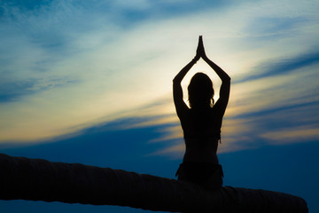 Silhouette of a woman doing a meditation pose, Lotus Pose
