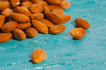handful of almonds on a blue wooden background