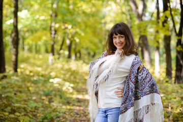 happy woman with scarf in the forest