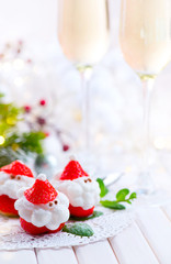 Christmas strawberry Santa. Funny dessert stuffed with whipped cream. Xmas party food idea