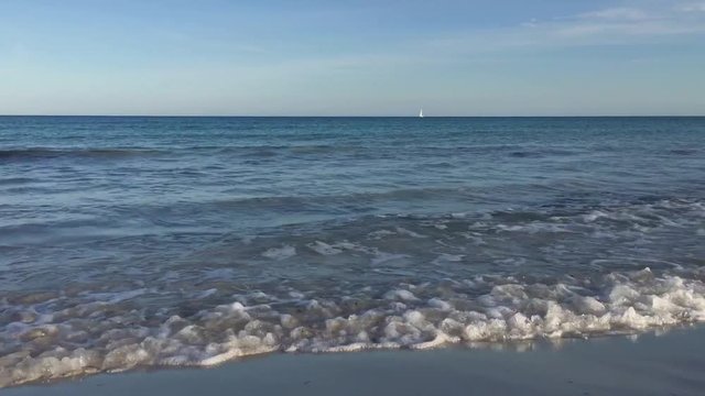 Mallorca, waves on sandy beach of Cala Bona