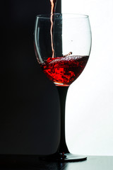 Red wine pouring. white on black background