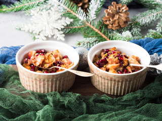 Christmas baked apple dessert with pomegranate in bowls