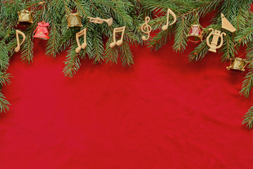 Musical notes, instruments on christmas tree brunch on red velvet 