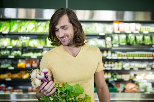 Man buying turnip in supermarket