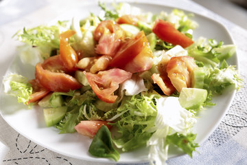 Plate of salad with various vegetables.