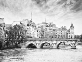 Naklejka premium Pont Neuf in central Paris, France. The Pont Neuf is the oldest standing bridge across the river Seine in Paris. Black and white. noise added